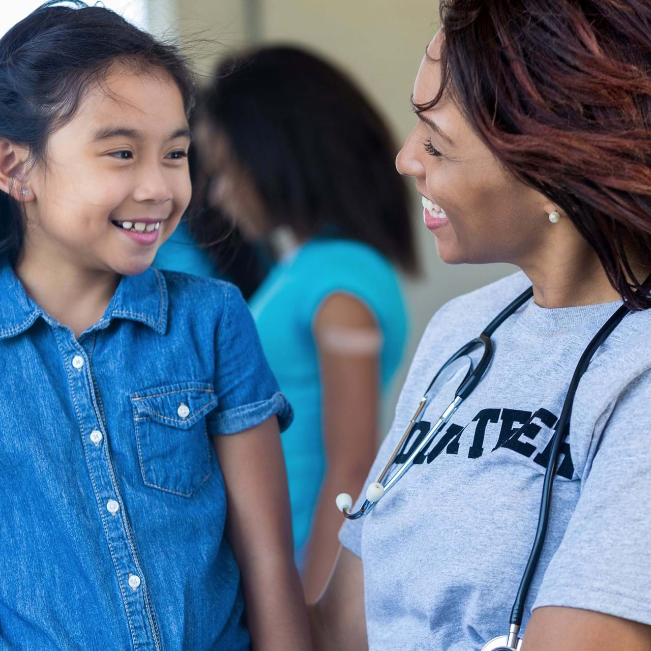 Medical professional smiling at child