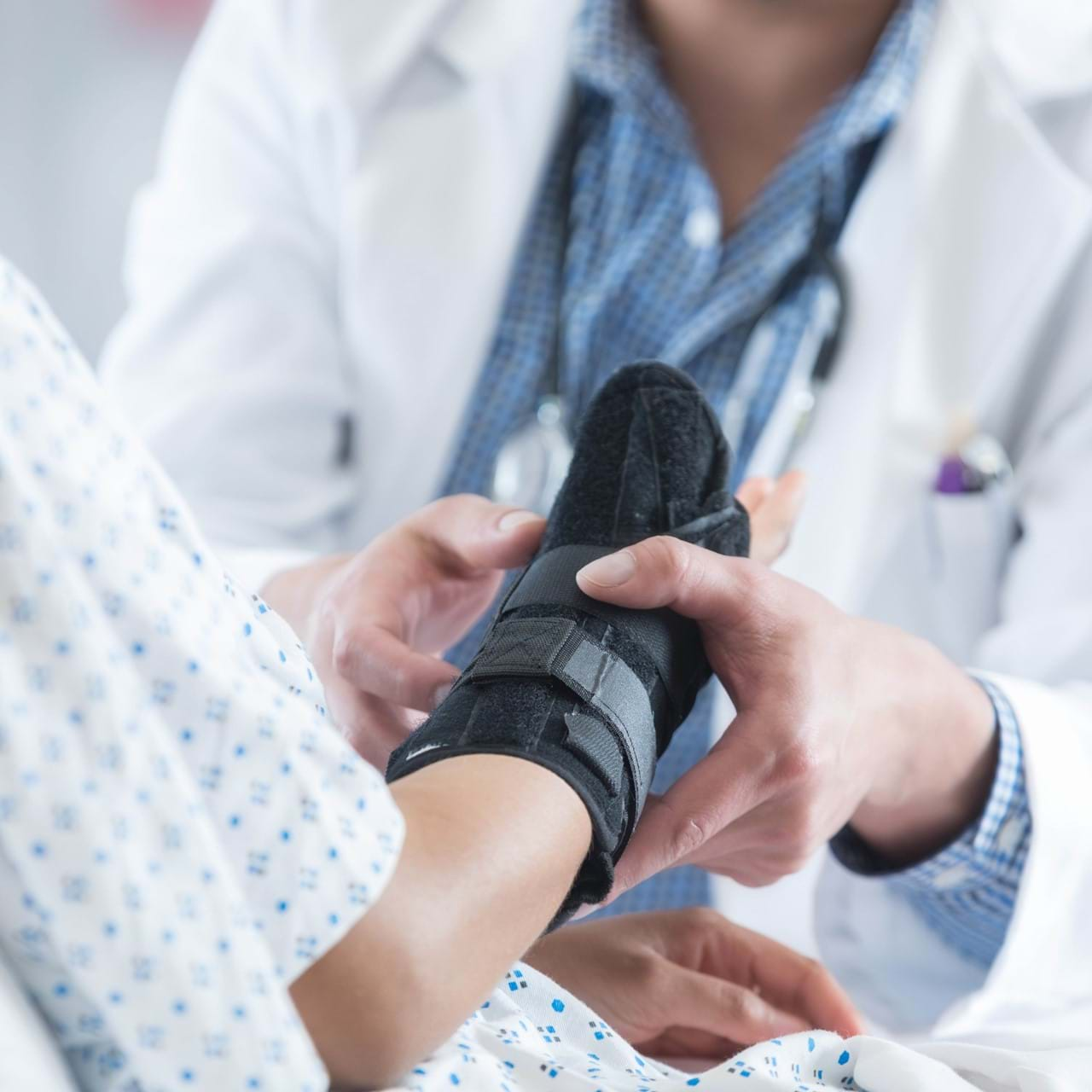 Doctor attending to patient's injured wrist