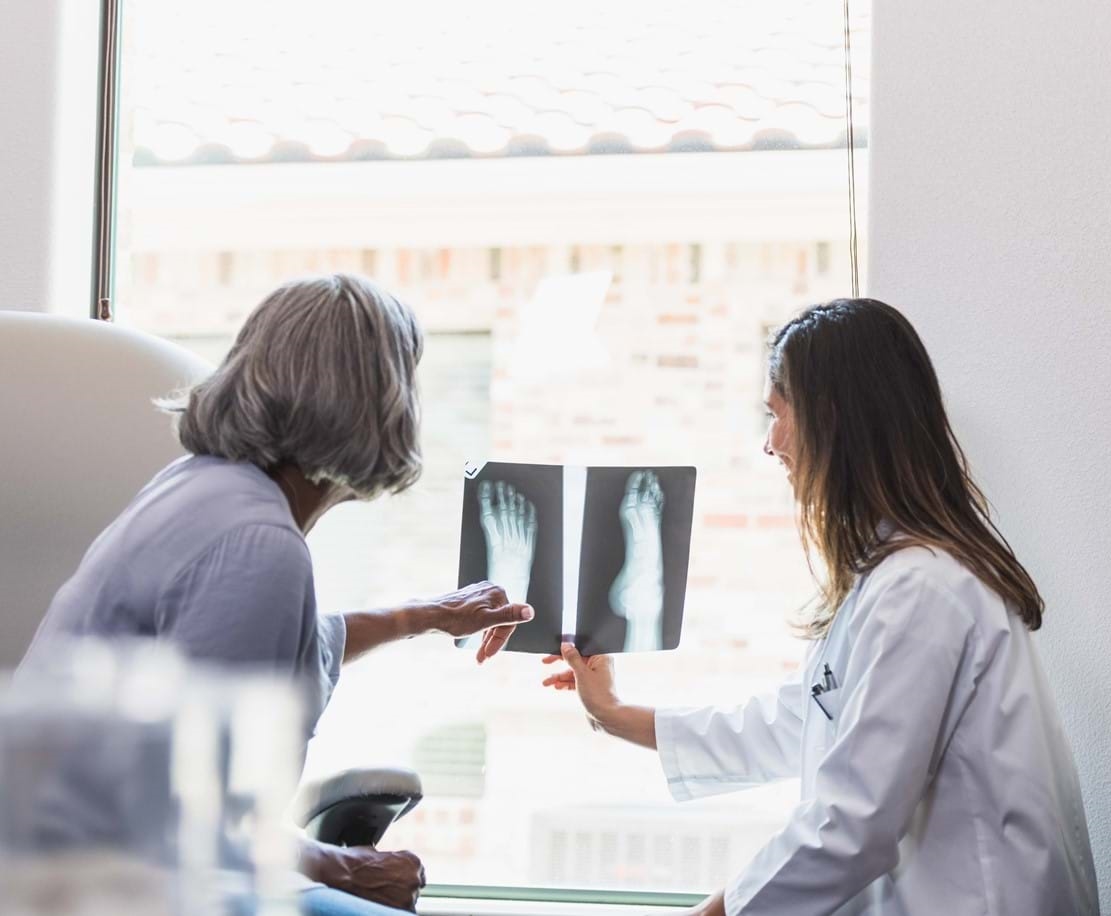 Doctor and Patient looking at Xrays of foot