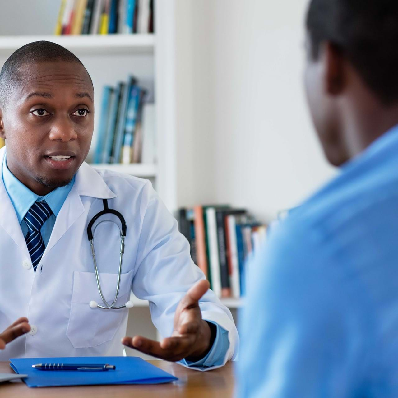 Doctor speak to male patient