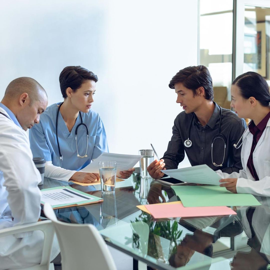 Medical professionals around conference table