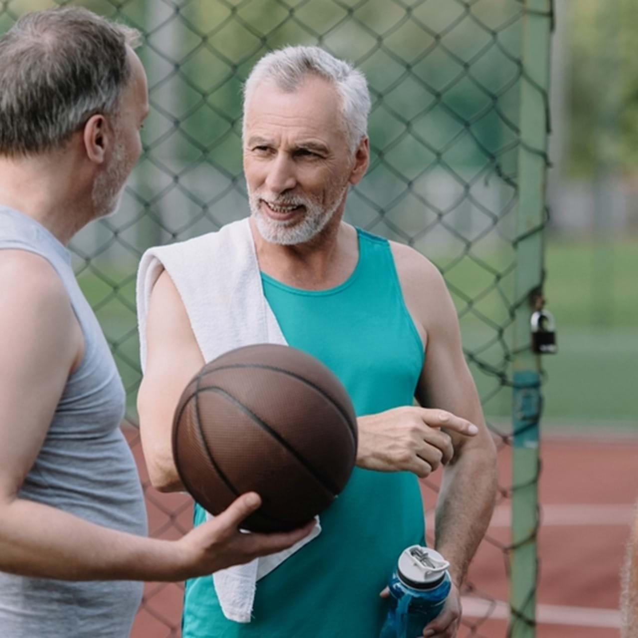 Two men playing basketball