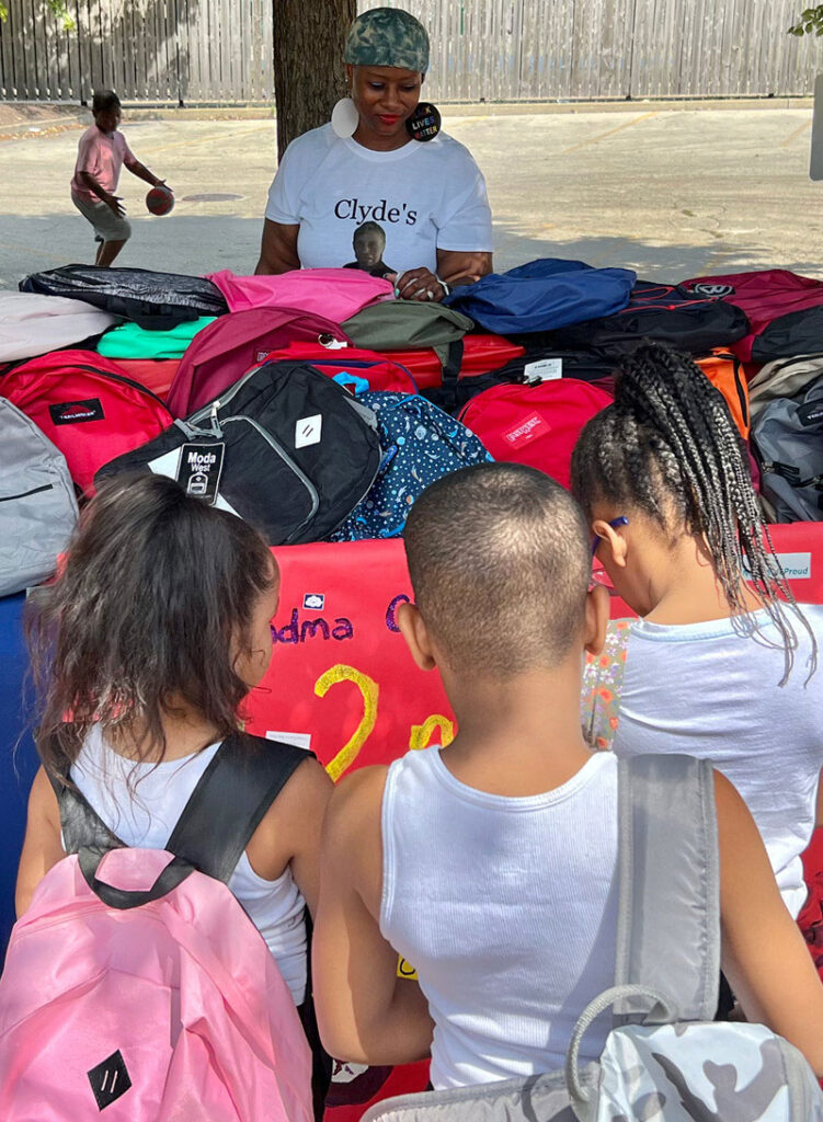 Children pick out backpacks